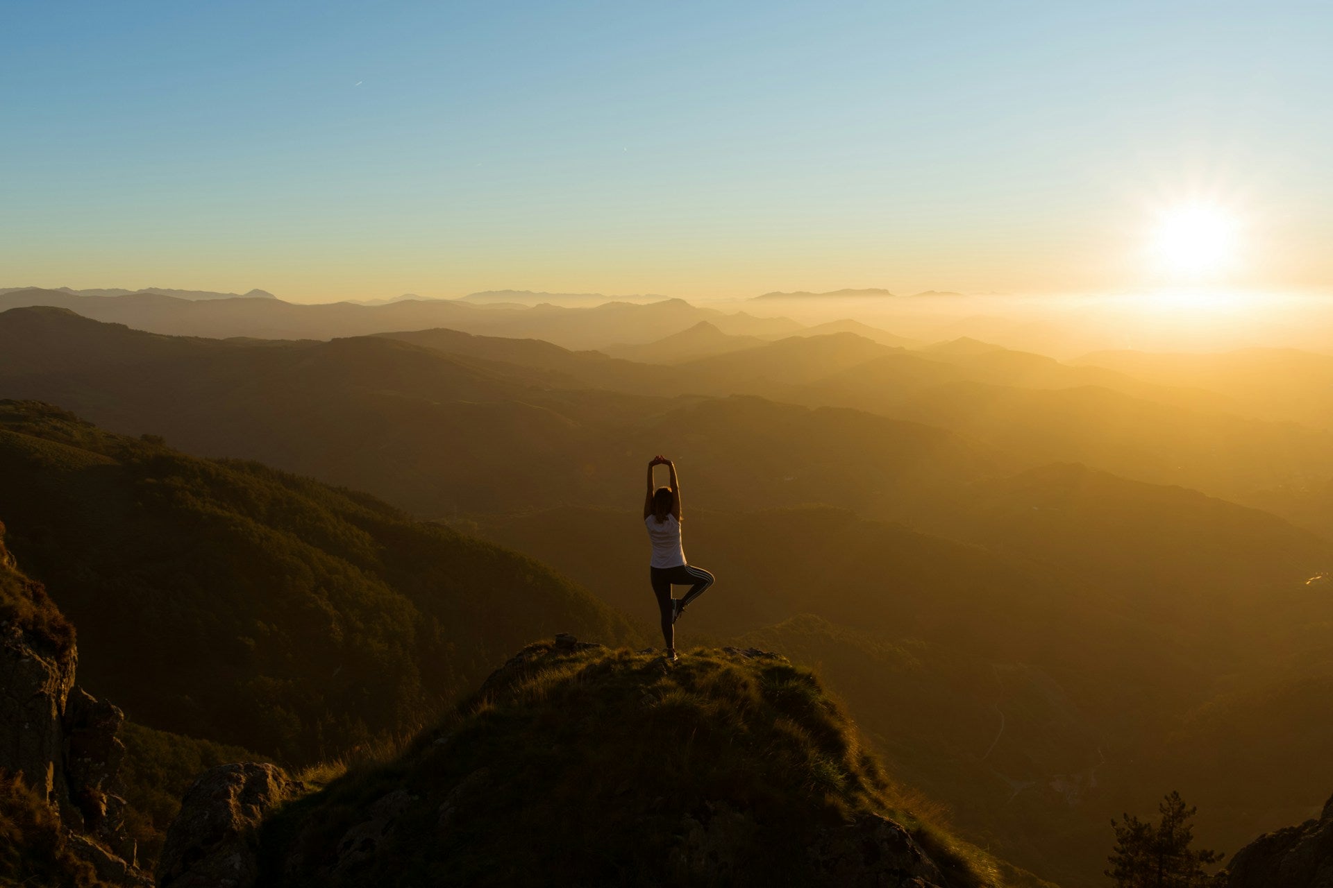 Woman stretching on mountain sunrise - BYS Store outdoor